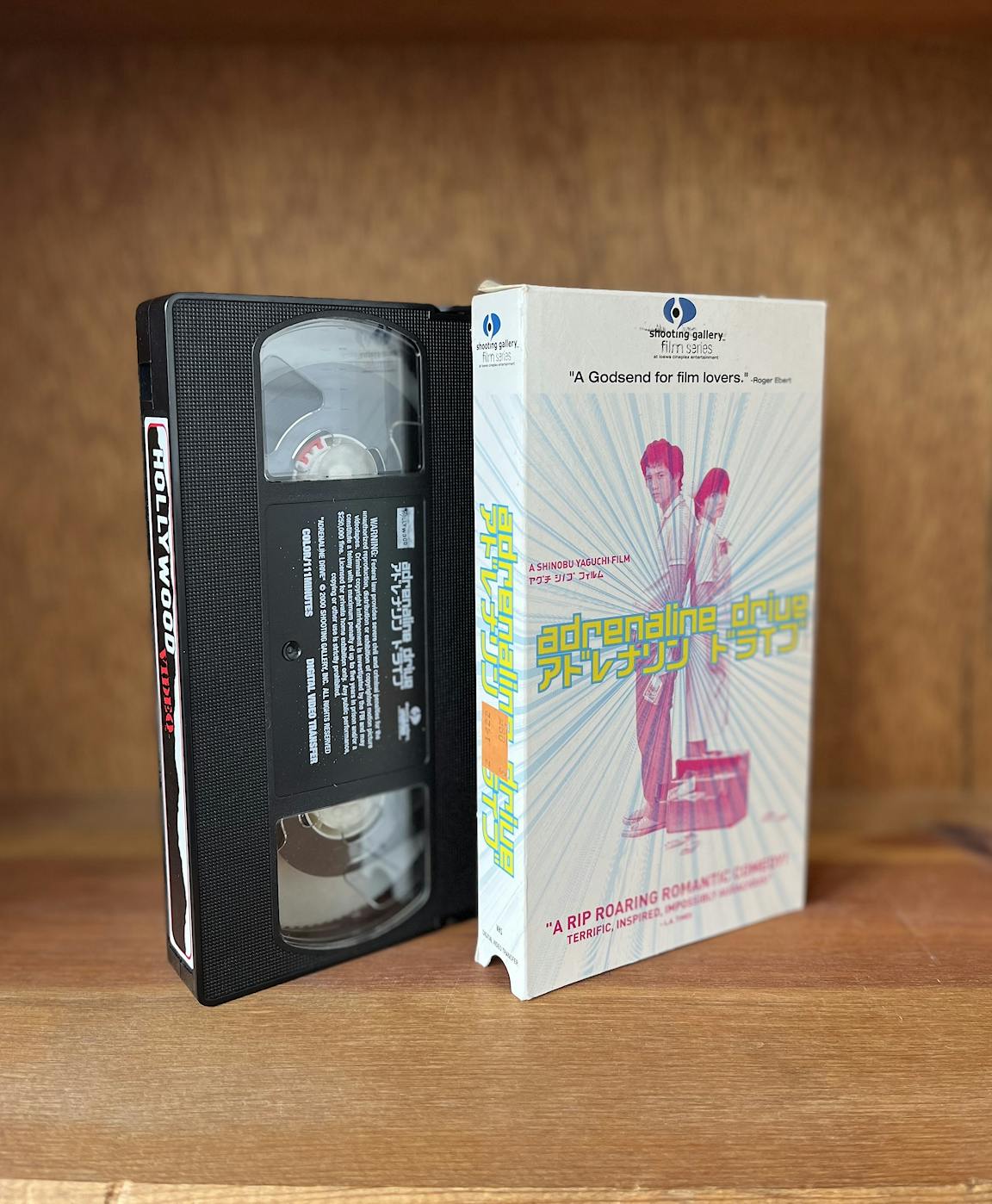 The VHS box cover and its tape for Adrenaline Drive.